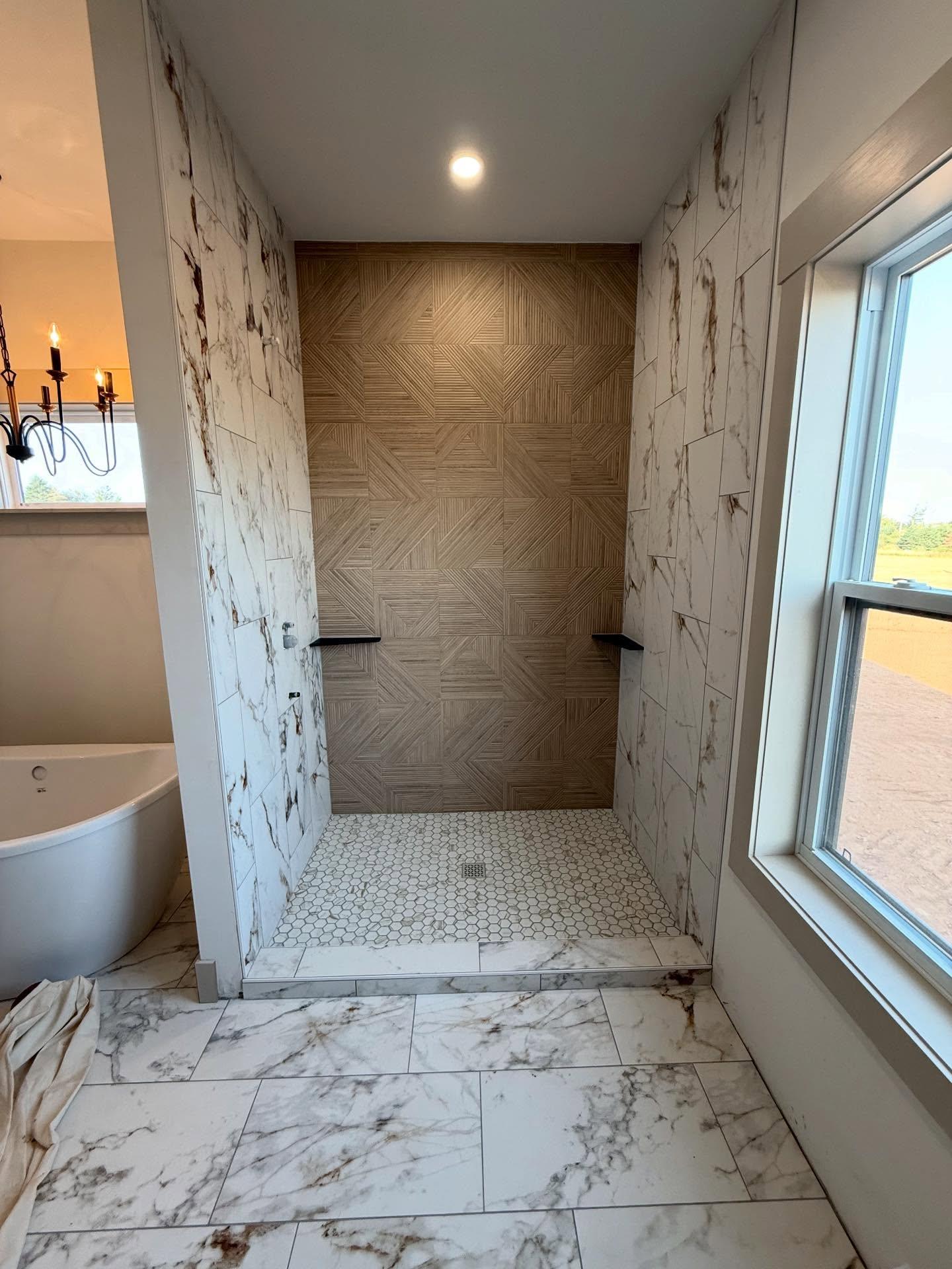Marble-look walk-in shower with patterned feature wall and hex floor